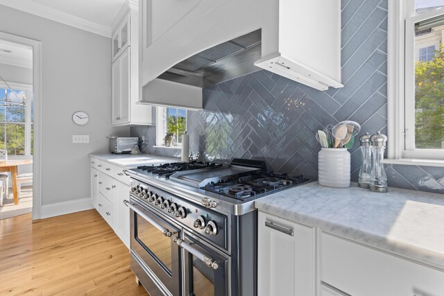 112 Berkshire Dr, Wando, SC 29492 - kitchen with ornamental molding, decorative backsplash, double oven range, and white cabinetry