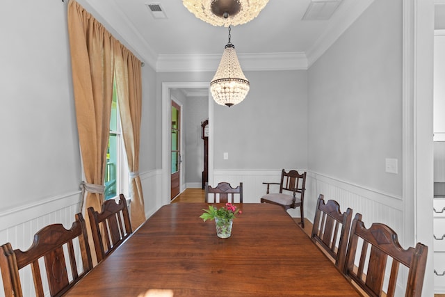 112 Berkshire Dr, Wando, SC 29492 - dining space with crown molding, a chandelier, visible vents, and wainscoting