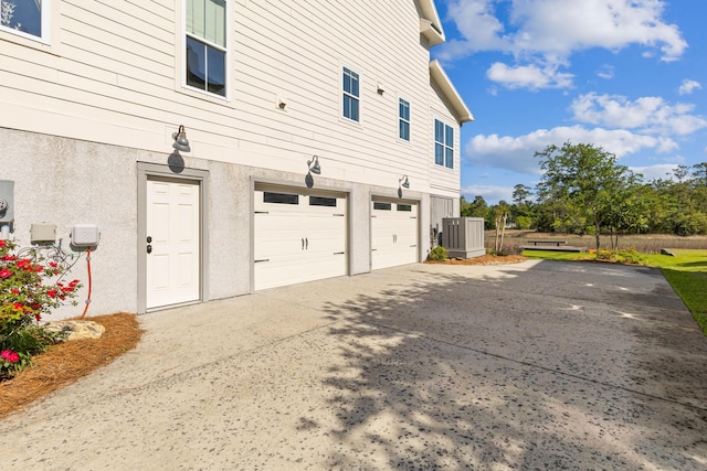 112 Berkshire Dr, Wando, SC 29492 - view of side of home with a garage, stucco siding, and driveway