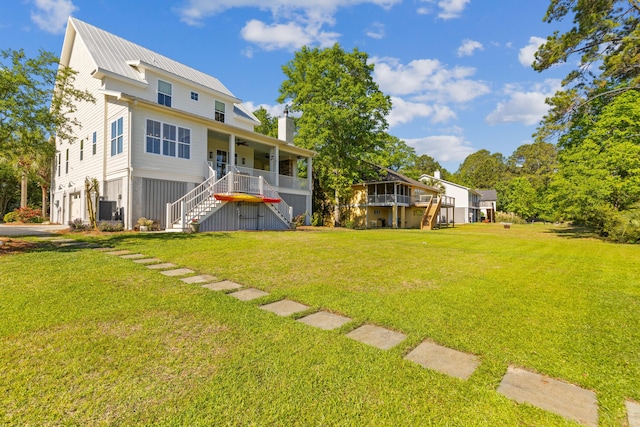 112 Berkshire Dr, Wando, SC 29492 - back of property with a yard, ceiling fan, an attached garage, and stairs