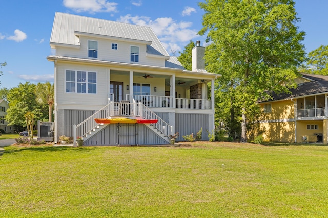 112 Berkshire Dr, Wando, SC 29492 - back of house featuring stairs, a ceiling fan, a yard, and metal roof