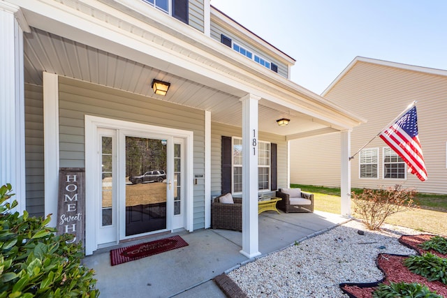 view of exterior entry featuring a porch