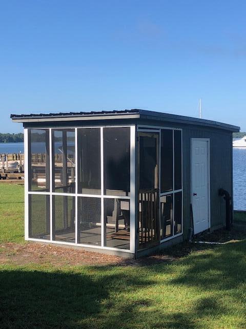 1205 Cypress Pointe Unit A205, Manning, SC 29102 - rear view of house with a yard, a sunroom, and a water view