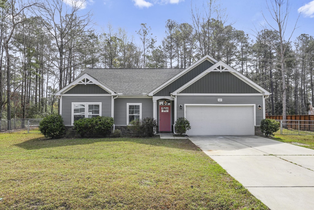 view of front of house with a front yard and a garage