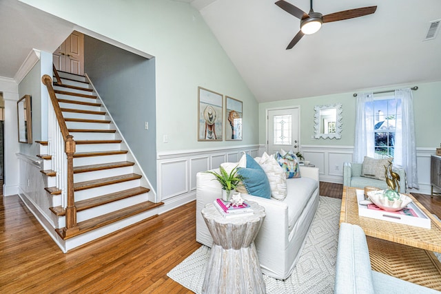 living room with lofted ceiling, a ceiling fan, stairway, and wood finished floors