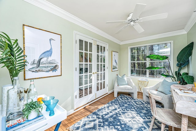 sunroom featuring a ceiling fan and french doors