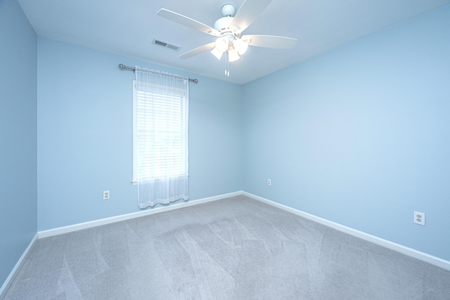 spare room featuring baseboards, carpet flooring, visible vents, and a ceiling fan