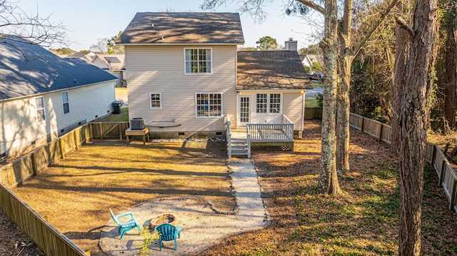 back of house featuring crawl space, a fenced backyard, a yard, and a deck