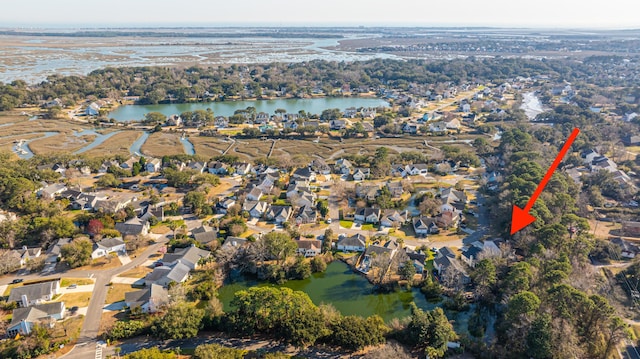 birds eye view of property featuring a water view and a residential view