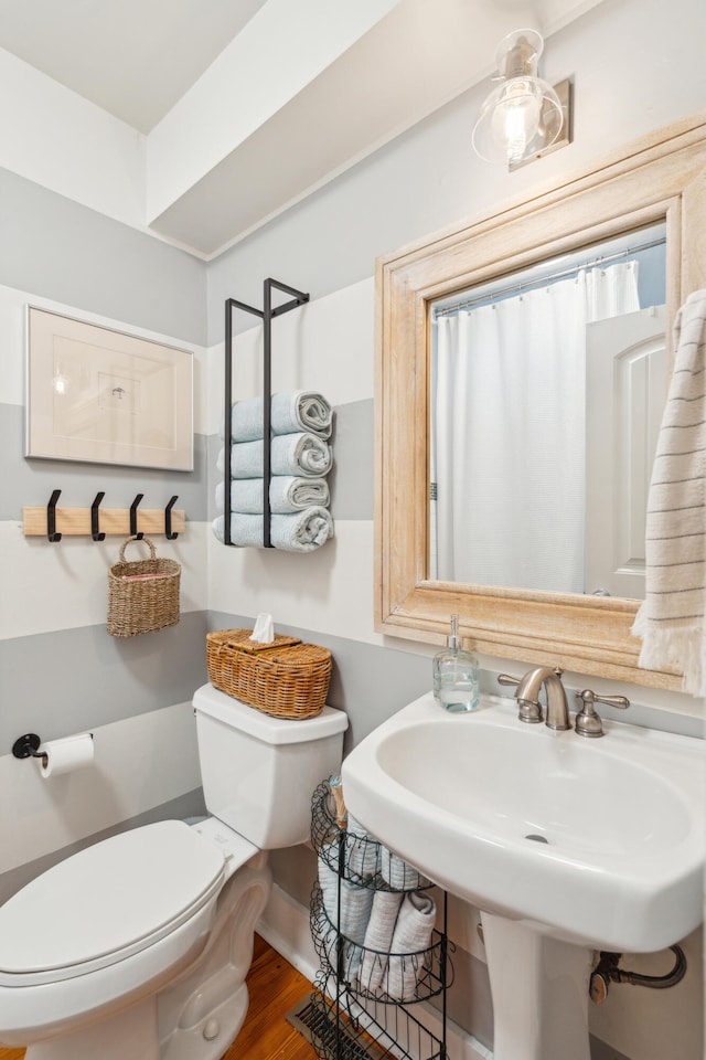 bathroom featuring hardwood / wood-style flooring, sink, and toilet