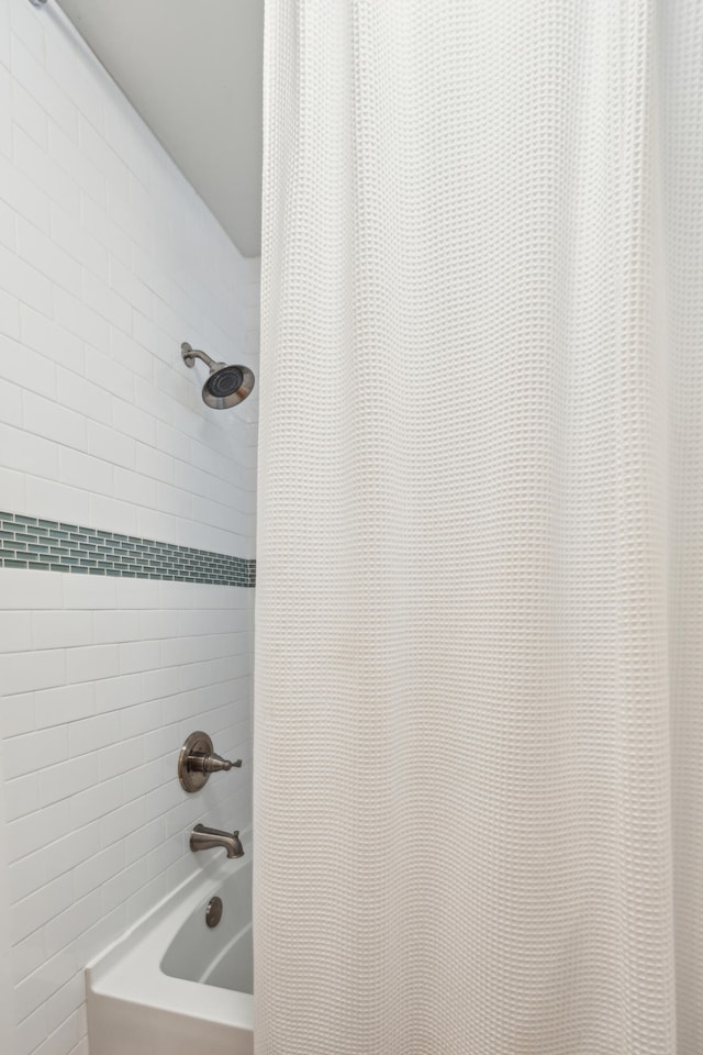 bathroom featuring shower / tub combo with curtain