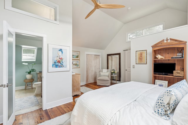 bedroom featuring ceiling fan, vaulted ceiling, light hardwood / wood-style floors, and multiple windows