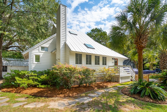 view of side of home featuring a wooden deck