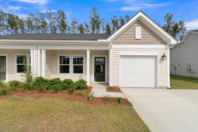 ranch-style house featuring a garage, a front yard, and covered porch