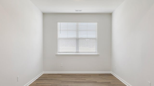 empty room with hardwood / wood-style flooring