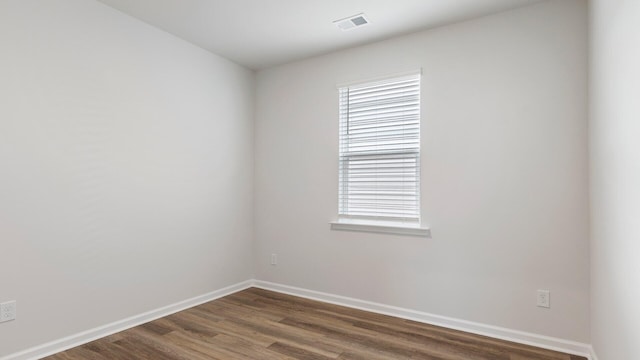 unfurnished room with dark hardwood / wood-style floors