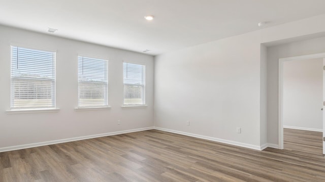 unfurnished room with hardwood / wood-style flooring