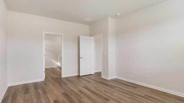 unfurnished bedroom with dark wood-type flooring