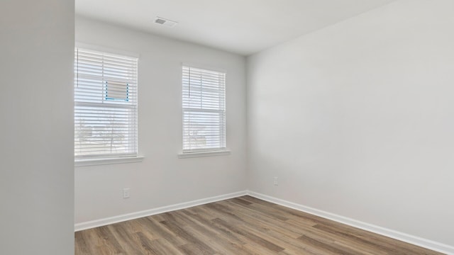 unfurnished room with hardwood / wood-style floors