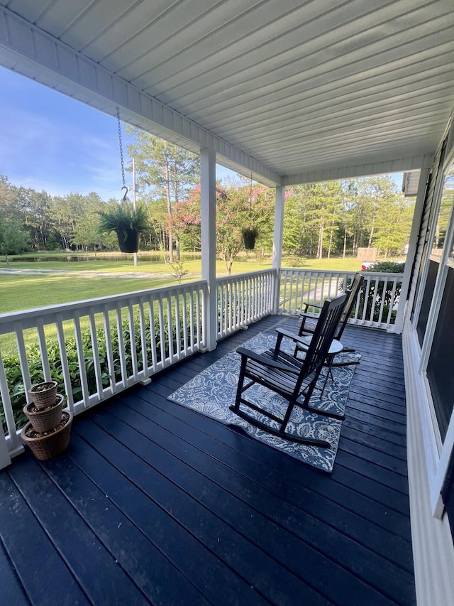1173 Penny Creek Dr, Ruffin, SC 29475 - wooden porch with a lawn and view of wooded area