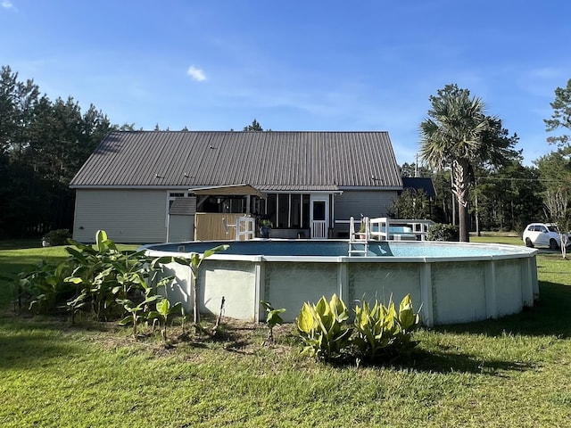 1173 Penny Creek Dr, Ruffin, SC 29475 - rear view of property with a metal roof, an outdoor pool, and a yard