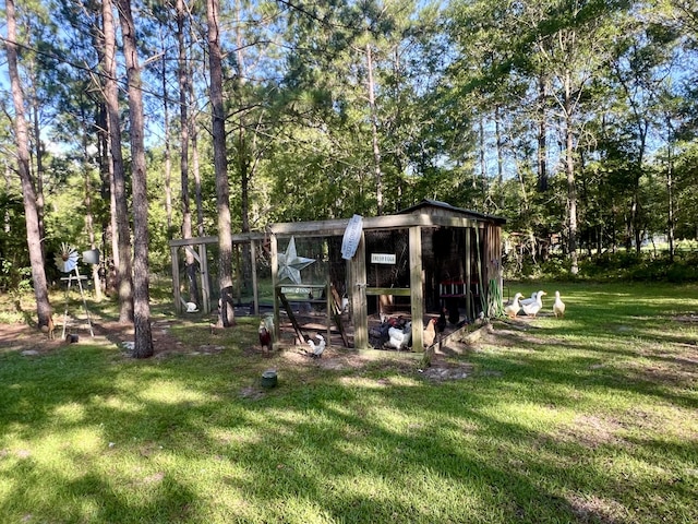1173 Penny Creek Dr, Ruffin, SC 29475 - view of green lawn featuring exterior structure, an outbuilding, and view of wooded area
