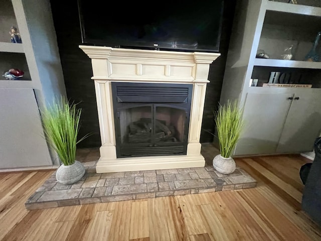 1173 Penny Creek Dr, Ruffin, SC 29475 - detailed view of a fireplace with raised hearth and wood finished floors