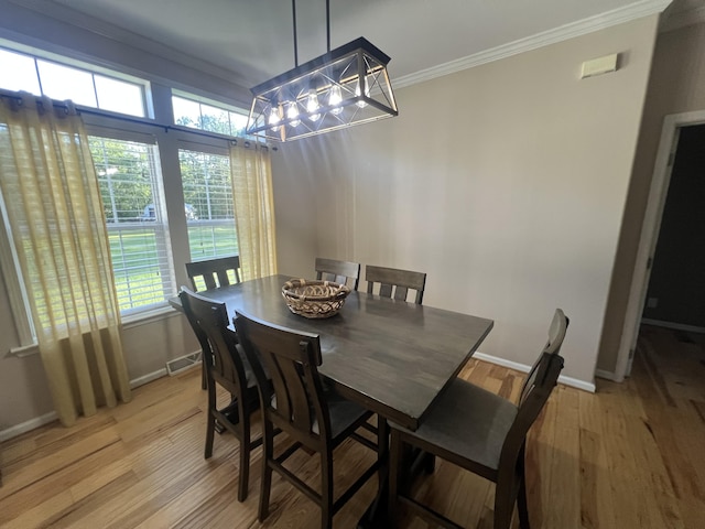 1173 Penny Creek Dr, Ruffin, SC 29475 - dining room with crown molding, a chandelier, and light wood-style floors