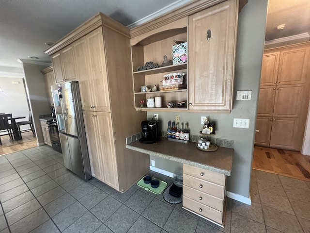 1173 Penny Creek Dr, Ruffin, SC 29475 - kitchen featuring freestanding refrigerator, ornamental molding, dark tile patterned flooring, light brown cabinetry, and built in desk