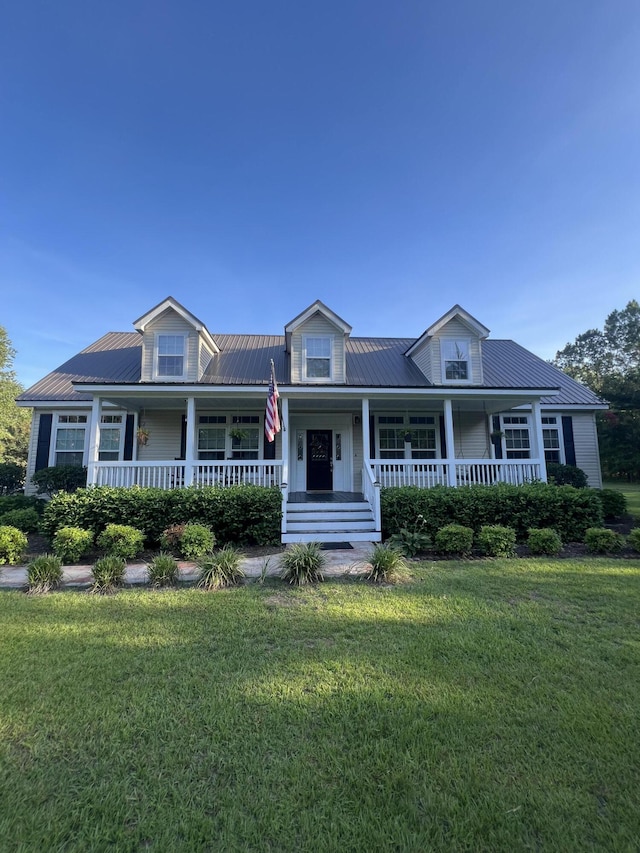 1173 Penny Creek Dr, Ruffin, SC 29475 - view of front facade with a porch, a front yard, and a metal roof