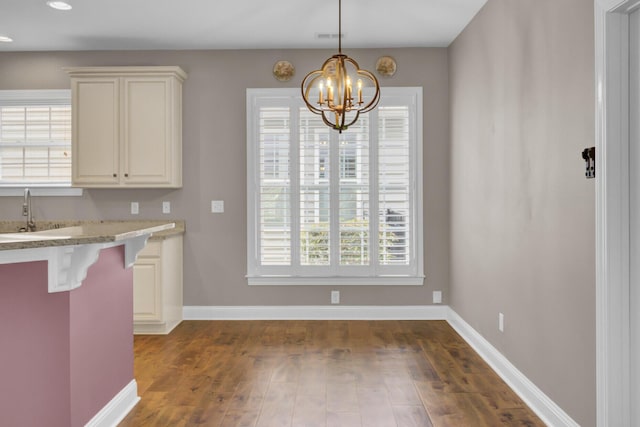 102 Brutus Ln, Summerville, SC 29485 - kitchen with dark wood-style floors, a sink, a breakfast bar area, and baseboards