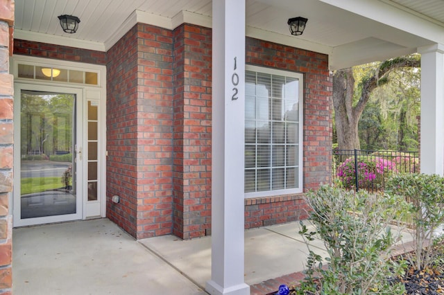 102 Brutus Ln, Summerville, SC 29485 - doorway to property with brick siding, fence, and a porch