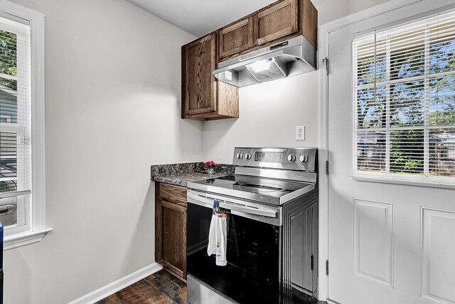 5806 Robinhood Dr, Hanahan, SC 29410 - kitchen featuring stainless steel electric range oven, under cabinet range hood, dark wood finished floors, baseboards, and dark countertops