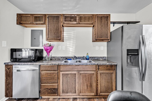 5806 Robinhood Dr, Hanahan, SC 29410 - kitchen with appliances with stainless steel finishes, a sink, electric panel, dark countertops, and wood finished floors