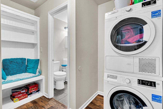 5806 Robinhood Dr, Hanahan, SC 29410 - laundry area featuring stacked washer and clothes dryer, dark wood-type flooring, and baseboards