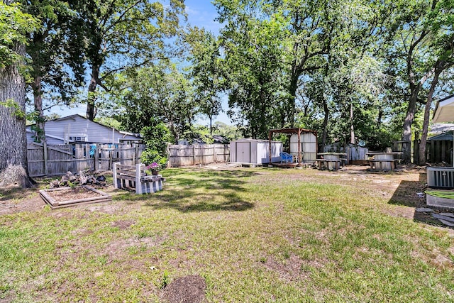 5806 Robinhood Dr, Hanahan, SC 29410 - view of yard featuring a storage unit, a garden, an outbuilding, and central AC unit