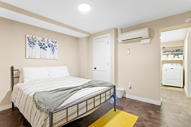 bedroom featuring washer / dryer and a wall unit AC