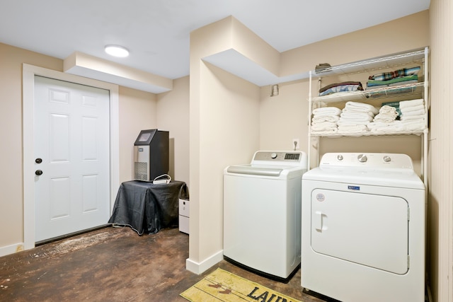 clothes washing area with separate washer and dryer