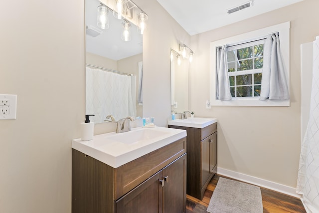 bathroom with vanity and hardwood / wood-style flooring