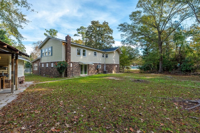 back of property featuring a lawn