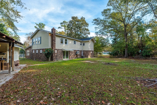 109 Beacon Ave, Moncks Corner, SC 29461 - back of property featuring a chimney, brick siding, and a lawn