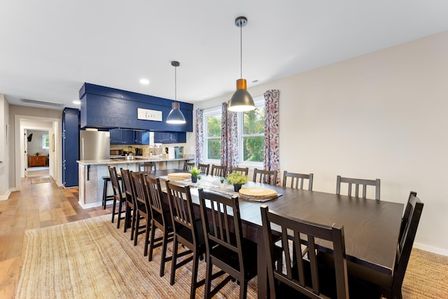 dining space with light hardwood / wood-style flooring