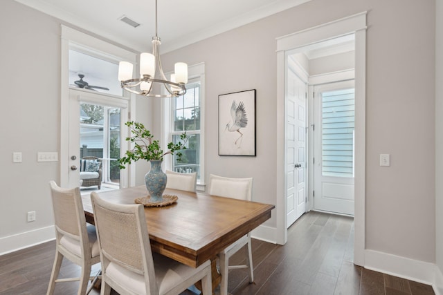 dining room with ceiling fan with notable chandelier, ornamental molding, and dark wood-type flooring