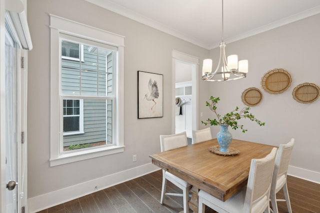 dining space featuring dark hardwood / wood-style flooring, ornamental molding, and a notable chandelier