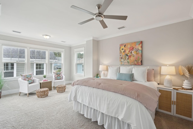 carpeted bedroom with ceiling fan and crown molding