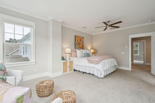 carpeted bedroom with ceiling fan and ornamental molding