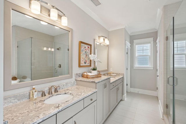 bathroom with tile patterned flooring, vanity, ornamental molding, and walk in shower