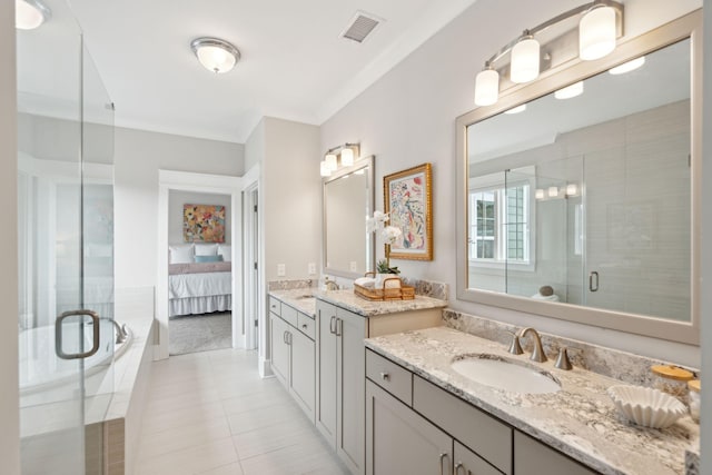 bathroom featuring tile patterned flooring, vanity, a shower with door, and ornamental molding