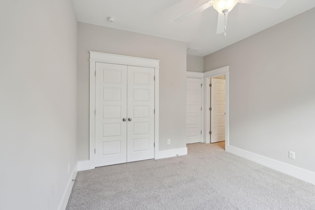 unfurnished bedroom with a closet, ceiling fan, and light colored carpet