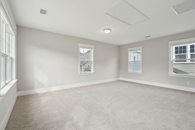 carpeted empty room with a healthy amount of sunlight